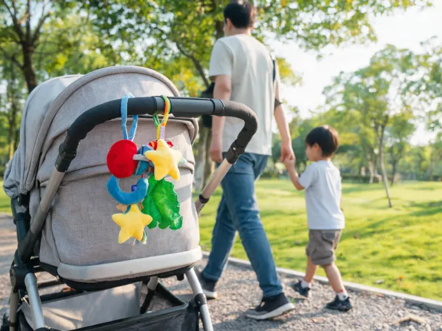 Baby stroller clip-on sensory toy during a family walk
